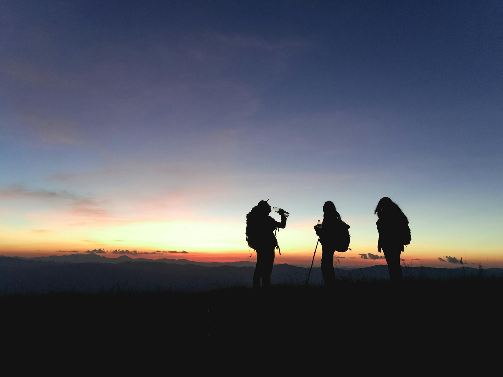 silhouette of three people